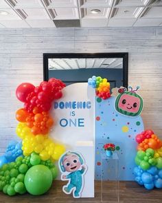 balloons and decorations are on display in front of a sign that says, domestic is one