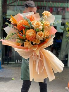 a woman holding a bouquet of flowers in her hands