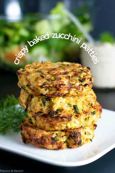 three cooked zucchini patties stacked on top of each other