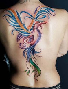 the back of a woman's body with colorful tattoos on her upper and lower back