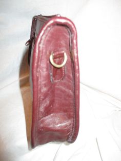 "Deep burgundy. Measures 10 3/4\" L X 2\" W X 6 1/2\" H. No designer or makers label. It has 1 exterior zip pocket. The interior has 1 zip pocket. Zip closure. The removable strap has a 17\" drop. Gold hardware. The exterior has a few light scuffs and the hardware has some tarnish. Some wear to the finish on the zipper pulls. The interior is like new. I ship same or next business day." Burgundy Satchel With Adjustable Strap For Formal Occasions, Formal Burgundy Satchel With Adjustable Strap, Formal Burgundy Crossbody Satchel, Burgundy Clutch Shoulder Bag For Travel, Burgundy Rectangular Shoulder Bag With Zipper Closure, Formal Burgundy Shoulder Bag With Zipper Closure, Formal Burgundy Shoulder Bag With Zipper, Classic Burgundy Shoulder Bag With Zipper Closure, Formal Crossbody Shoulder Bag With Zipper