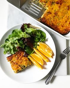 a white plate topped with food next to a fork