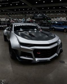 a silver sports car parked in a garage