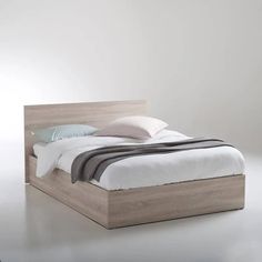 the bed is made up and ready for someone to use it in their home or office