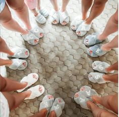 a group of people standing in a circle with their feet on top of each other