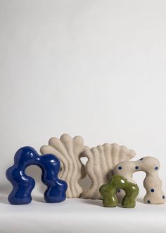 three ceramic figurines sitting next to each other