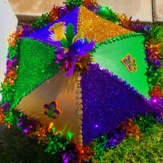 an umbrella decorated with mardi gras decorations