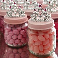 two jars filled with pink and white candies