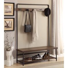 a coat rack with shoes and purses hanging on the wall next to a window