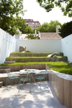 an outdoor dining area with wooden steps and grass