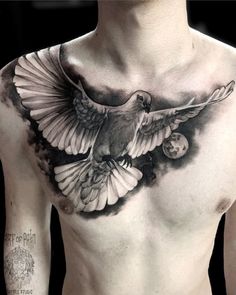 a man's chest with a bird tattoo on it