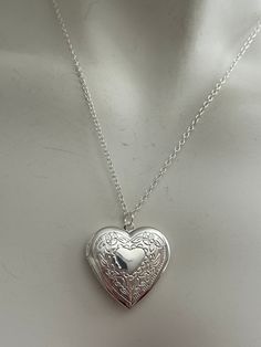 Engraved heart jewelry locket. Great condition, no tarnish, metal likely plated. One necklace Measures: 20 inches long Locket: 2.8cm For more gold lockets: Www.Etsy.com/shop/Ashley3535 Locket Necklace Heart, Big Heart Pendant Necklace, Silver Necklace Locket, Silver Heart Locket Necklace, Lockets Silver, Locket Heart Necklace, Silver Heart Pendant Necklace, Locket Necklace Silver, Silver Heart Locket