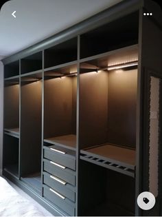 an empty walk in closet with drawers and lights