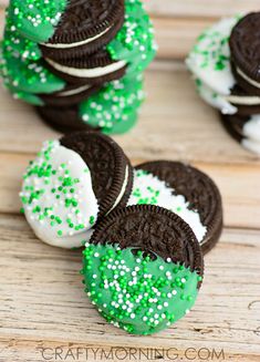 oreo cookies with green sprinkles and white frosting are on top of each other