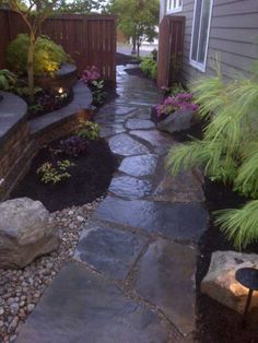 a stone path in the middle of a yard