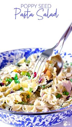 a pasta salad in a blue and white bowl with a fork sticking out of it