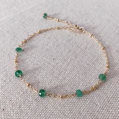 * DETAILS * This dainty natural emerald bracelet is a perfect gift to the one you love or to yourself. A nice every day bracelet. - Genuine Faceted Zambian Emerald Beads - 14K Gold Filled Chain - 14K GOLD FILLED Wire - 14K Gold Filled Bead Cap - 14K Gold Filled Lobster Clasp - 14K Gold Filled Link Rings ✨All components are gold filled. 👉🏻You may also like https://www.etsy.com/JinnysJewelryBySeJin/listing/1074721295/natural-emerald-14k-gold-filled-necklace?utm_source=Copy&utm_medium=Listing Dainty Green Beaded Bracelets For Everyday, Green Chain Bracelet For May Birthstone Gift, Handmade Everyday Bracelets For May Birthstone, Handmade Everyday Bracelet For May Birthstone, Dainty Green Bracelets For Everyday, Dainty Bracelets With May Birthstone For Everyday, Delicate Green Bracelet As Gift, Dainty Green Everyday Bracelets, Adjustable Emerald Bracelet As A Gift