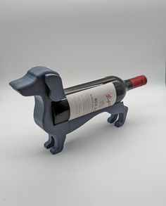 a wine bottle holder shaped like a dachshund