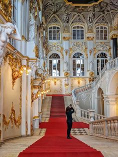 an ornate building with red carpet and stairs