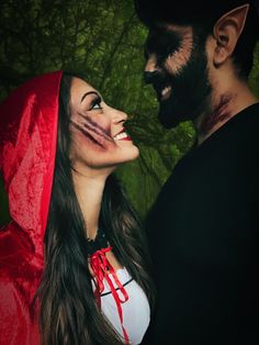 a man and woman dressed up as dracula and vampire girl with blood on their face