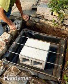 a man is working on an outdoor hot water heater that has been built into the ground