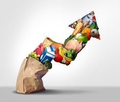 a paper bag filled with assorted fruits and vegetables floating into the shape of a man's head