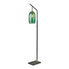 a floor lamp with a green glass shade on the top and a black metal base