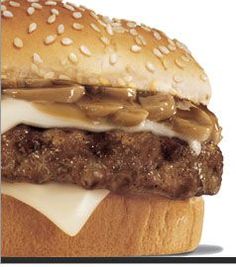 a hamburger with cheese and onions on it