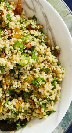 a white bowl filled with rice and vegetables