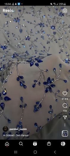 an image of a dress with blue beads and jewels on the bottom, as well as text that reads reels