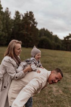 a man carrying a child on his back in a field