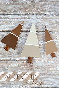 three wooden christmas trees painted brown, white and tan with the words paint chip above them