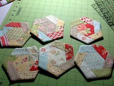 four hexagons are laid out on the table to be sewn together