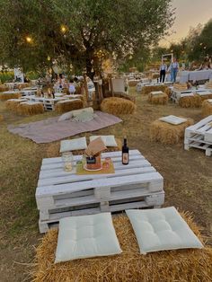 an outdoor event with hay bales and picnic tables set up in the middle of it