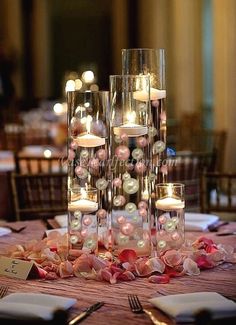 an elegant centerpiece with candles and flowers is displayed on the table at this wedding reception