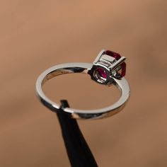 It is a lab ruby ring, octagon cut, measures 7mm*7mm, weight about 1.95 cts. The basic metal is sterling silver and plated with rhodium. To change the metal to a solid gold (white/rose) or platinum is also available, please ask for a quotation if you want. You can also go to my shop Home for more elegant rings: https://www.etsy.com/shop/godjewelry?ref=hdr_shop_menu ruby is birthstone of July More ruby rings: https://www.etsy.com/shop/godjewelry?ref=seller-platform-mcnav&section_id=20709238 C Octagon Red Ruby Ring As Gift, Octagon Ruby Ring For Gift, Red Octagon Ruby Ring Gift, Silver-colored Ruby Diamond Ring In Round Cut, Octagon-shaped Red Ruby Ring, Red Gemstone Ring, Red Gemstones, July Birthstone, Elegant Ring