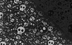 black and white skull wallpaper with lots of skulls in the middle, all on one side