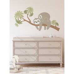 a baby slotty sleeping on a tree branch wall decal in a child's room