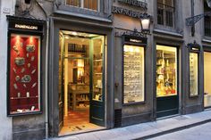 a store front with many items displayed in the windows and on the side of the building