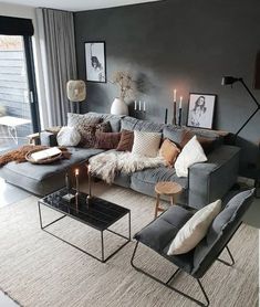 a living room filled with lots of furniture and decor on top of a carpeted floor