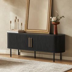 a large mirror sitting on top of a black cabinet