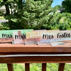 three clear acrylic signs that say i am miss, bed mes, and foster