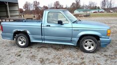 a blue pick up truck parked in a parking lot