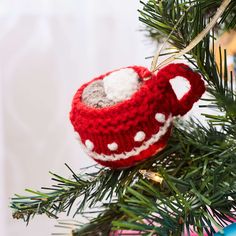 a knitted teapot ornament hanging from a christmas tree