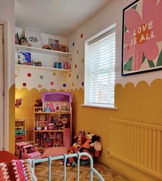 a child's bedroom decorated in pink and yellow