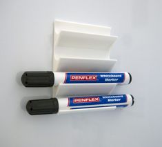 three penflex whiteboard markers sitting next to each other