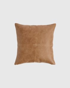 a brown pillow on a white background