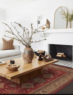 a living room filled with furniture and a fire place in front of a white couch