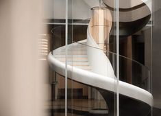 a spiral staircase in a building with glass walls