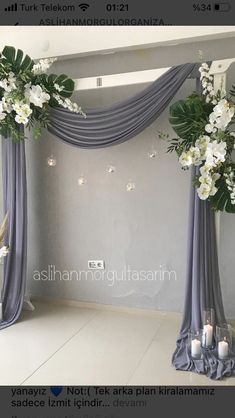 the wedding arch is decorated with flowers and candles